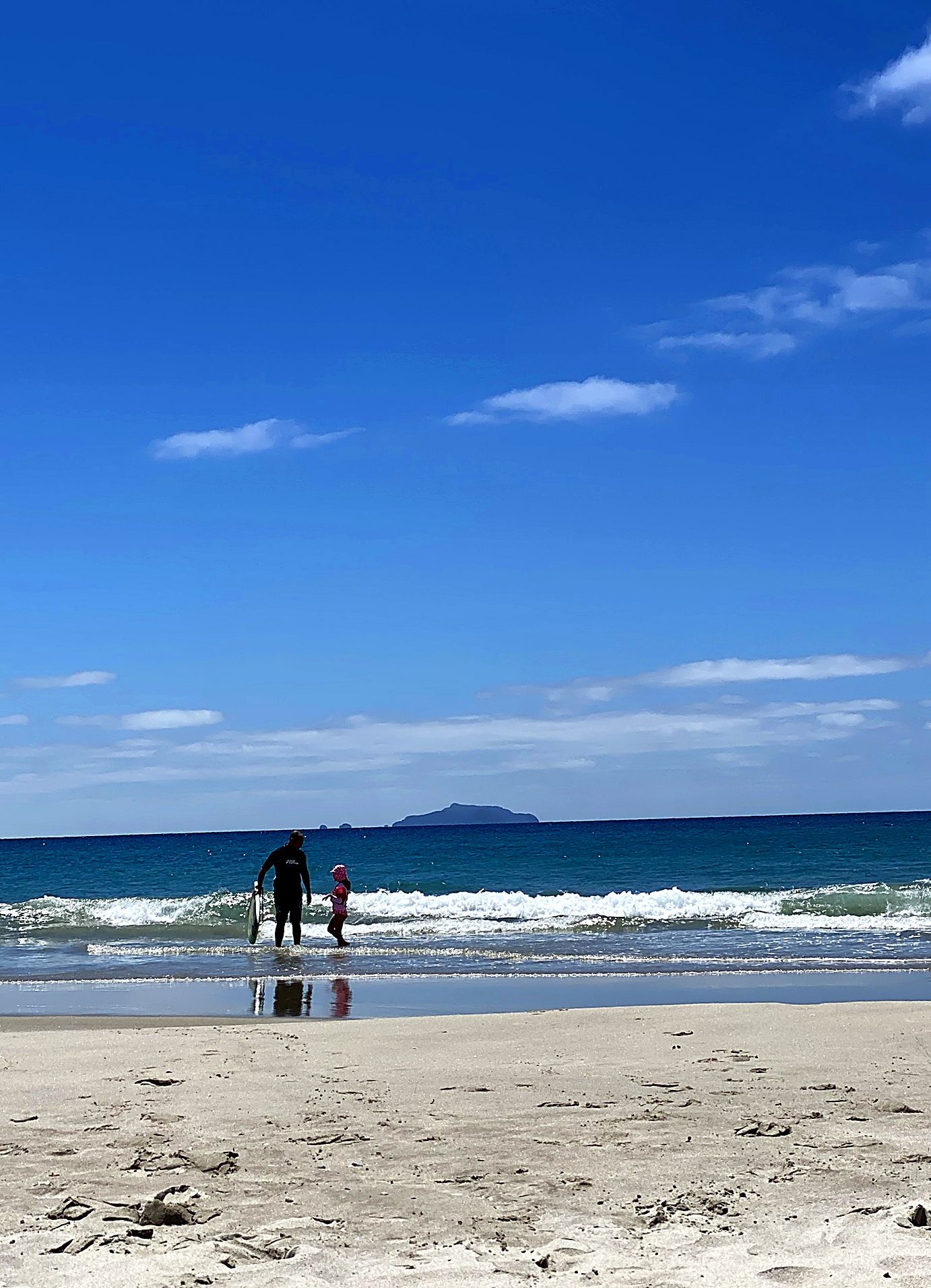 Kids in the shallows on a calm afternoon