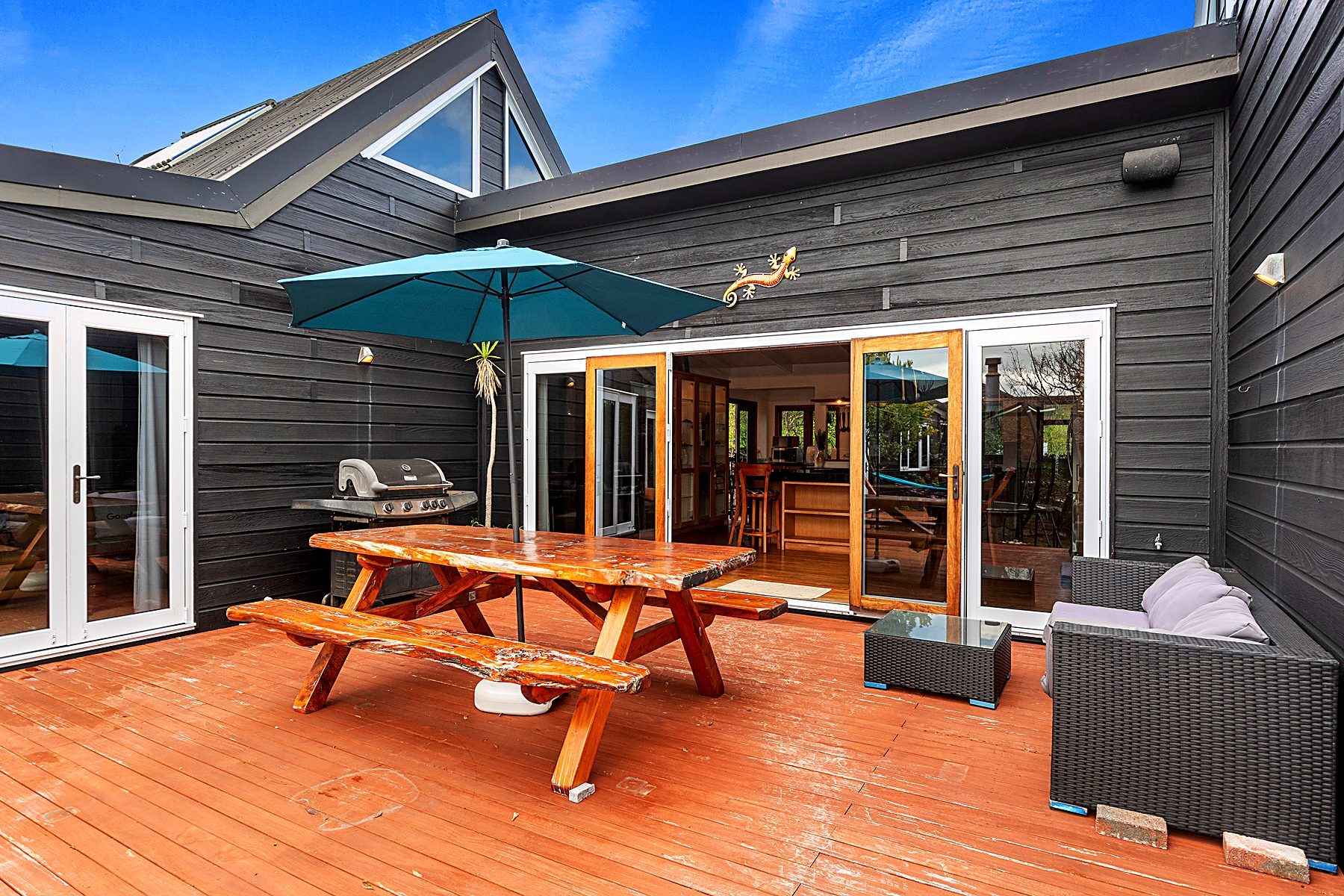 Evening around the outdoor table at Ruakākā Coastal Escape